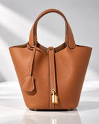 Women's orange leather bag close-up — everyday — Mara Leather Bucket Bag — Oscar Blackwood
